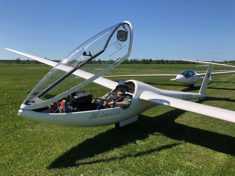 Bashar seated in a glider cockpit with the canopy open at the Montreal Soaring Club, Hawkesbury, Canada
